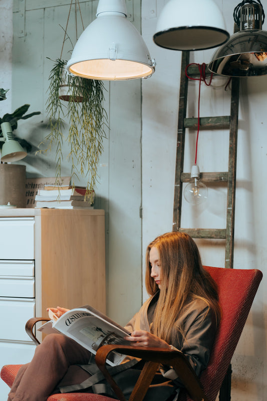 person reading under a lamp