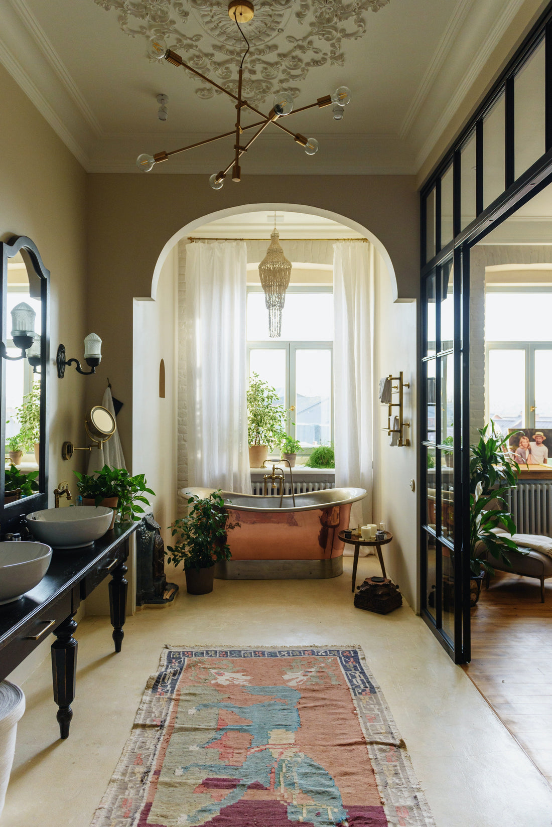 Chandelier in bathroom over bath tub